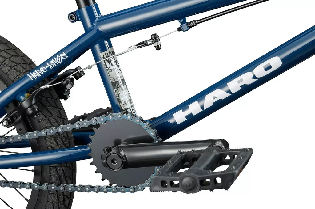 Détails de la chaîne, du pédalier et du cadre bleu d'un vélo BMX Haro.