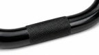 Close-up of black BMX handlebar with textured grip area, bike part detail