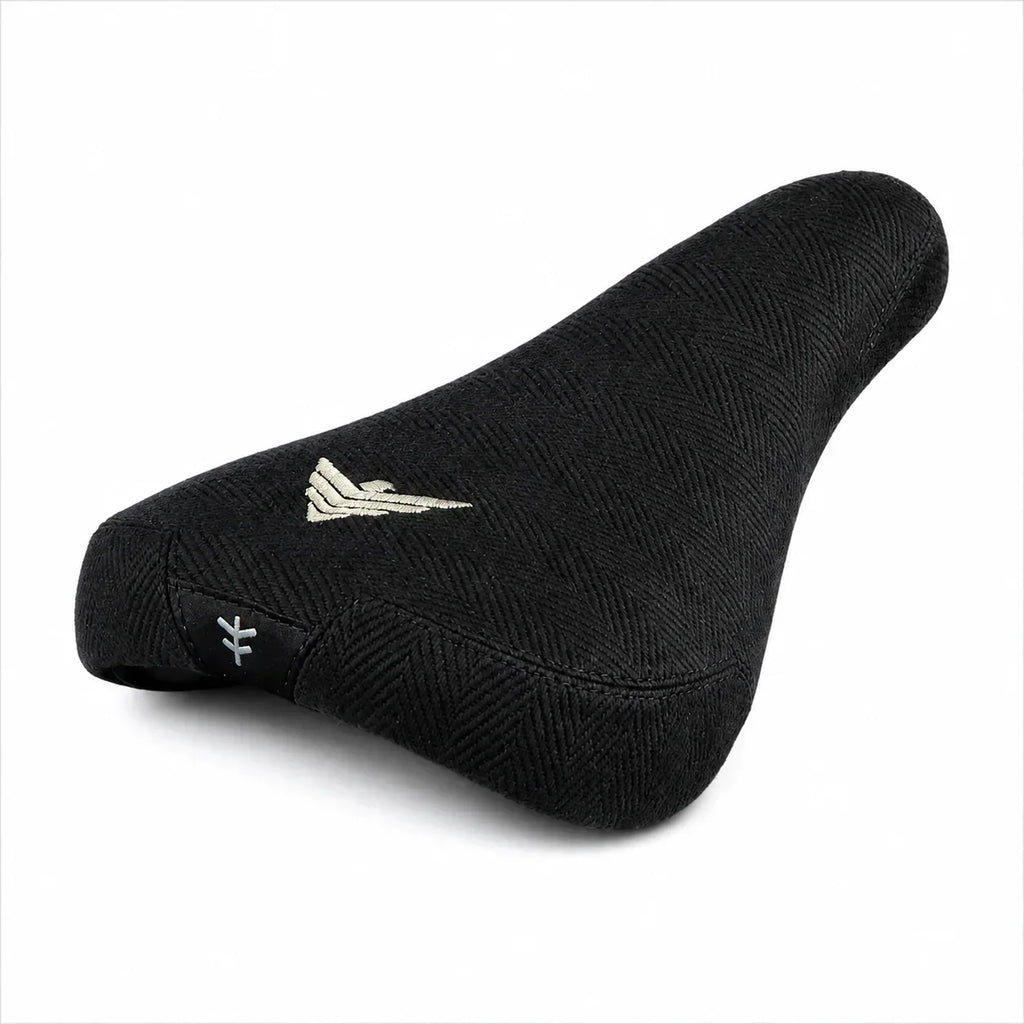 Selle BMX noire texturée avec logo doré et symbole distinctif