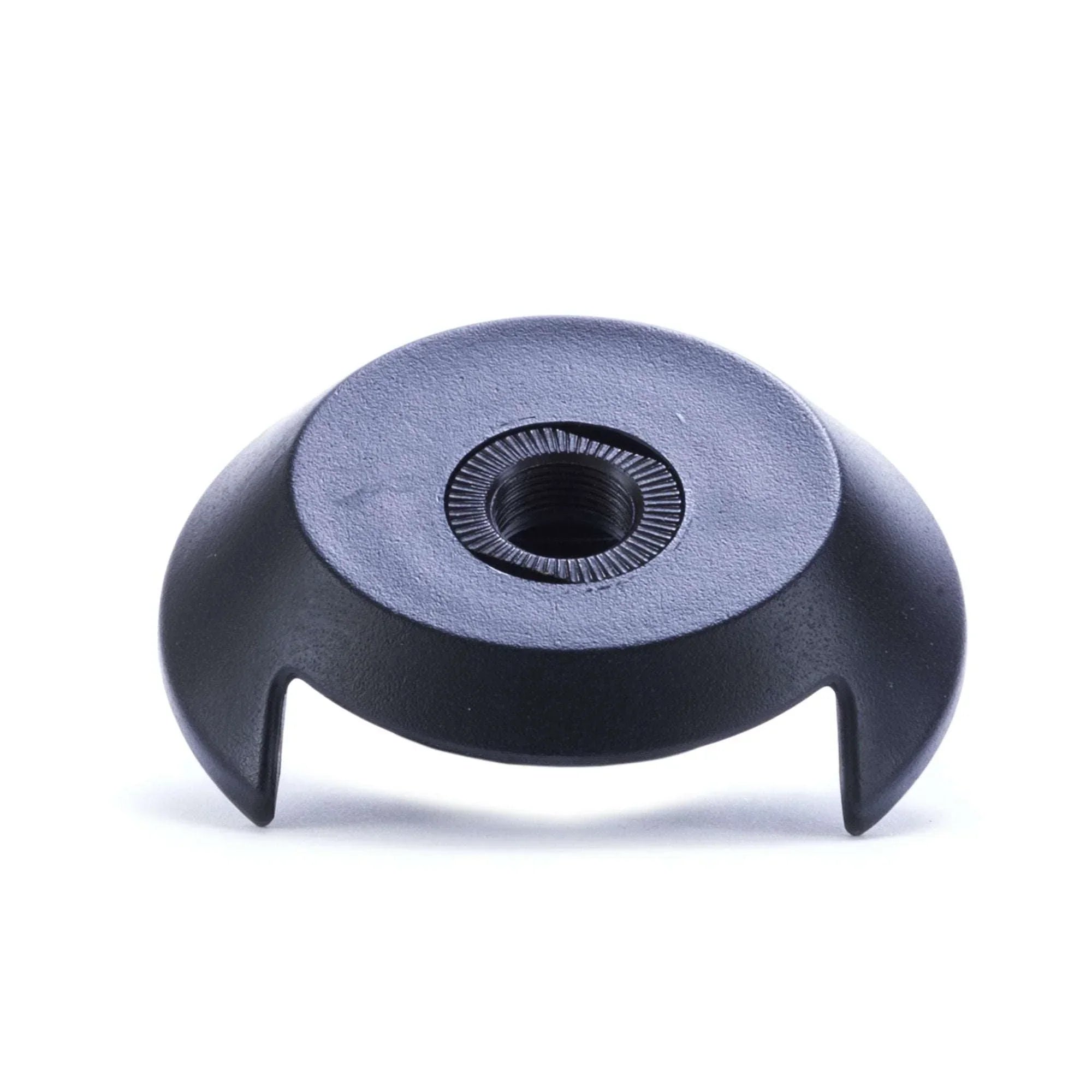 Black BMX driveside hub guard with central threaded hole on white background