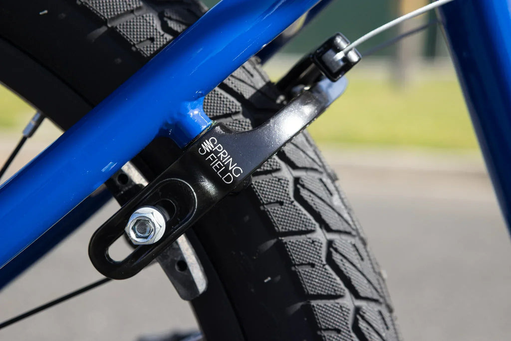 Gros plan d'un tendeur de chaîne Springfield noir sur un cadre de vélo BMX bleu