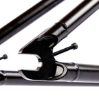 Close-up of black BMX bike frame dropout with tensioner screw, isolated on white