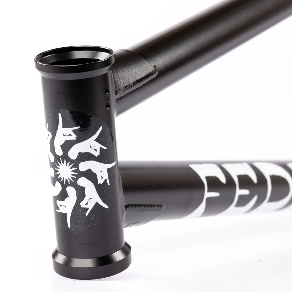 Matte black BMX bike frame with white graphics and bold lettering on the downtube