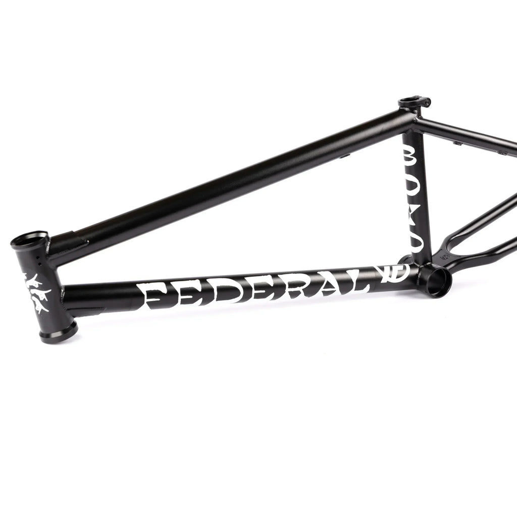 Black BMX bike frame with bold white graphics on a white background