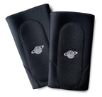 Pair of black padded knee pads with white logo, BMX protective gear isolated on white