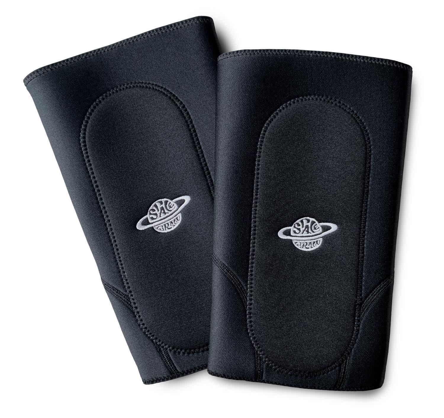 Pair of black padded knee pads with white logo, BMX protective gear isolated on white