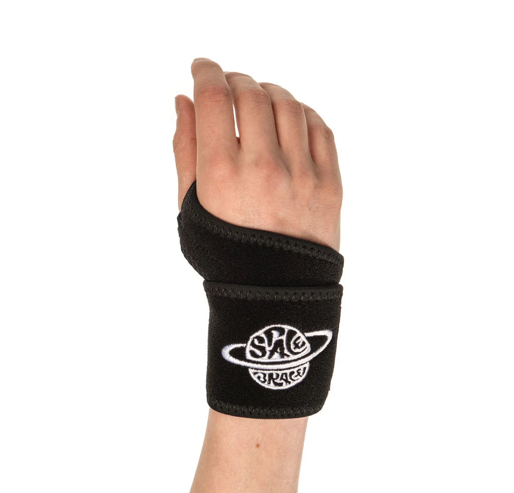 Black BMX wrist support brace on hand, white logo, on white background
