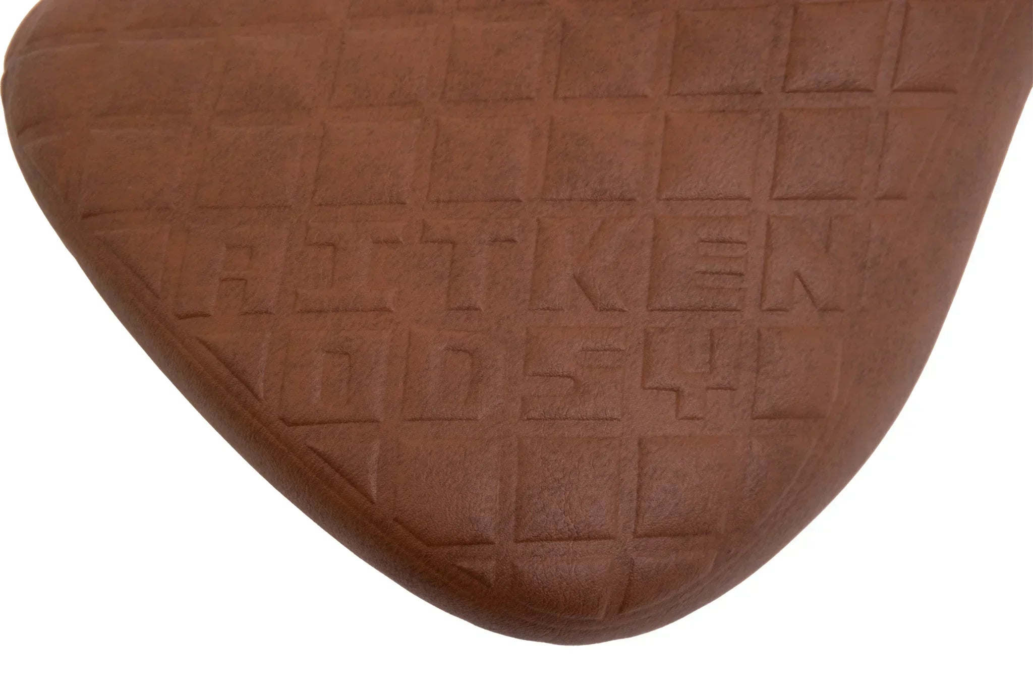 Selle BMX marron avec motif quadrillé et logo gravé, design ergonomique pour vélo freestyle