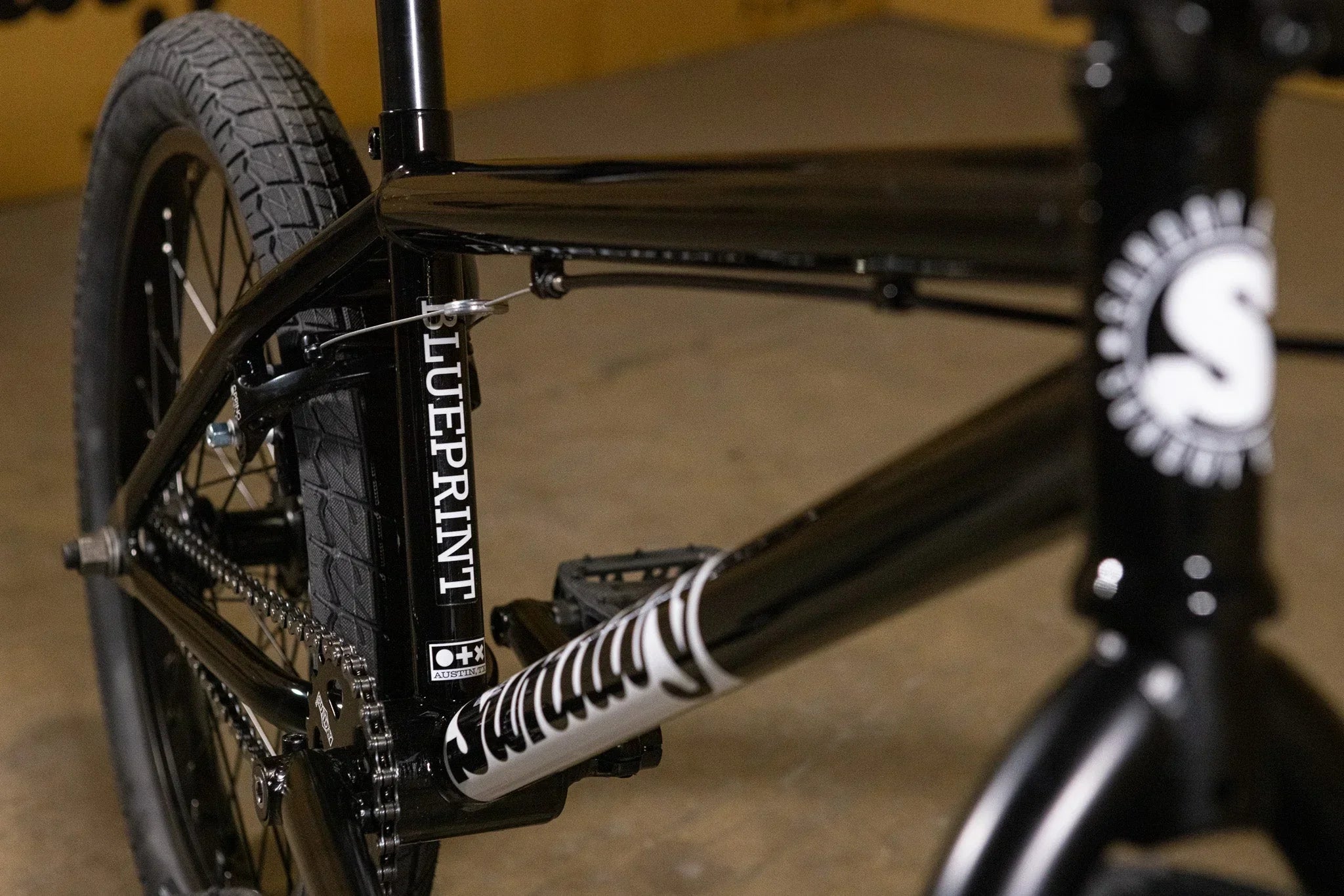 Détail du cadre noir d'un vélo BMX Blueprint avec pneus tout-terrain.