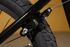 Gros plan d'un frein arrière Springfield noir monté sur un vélo BMX.