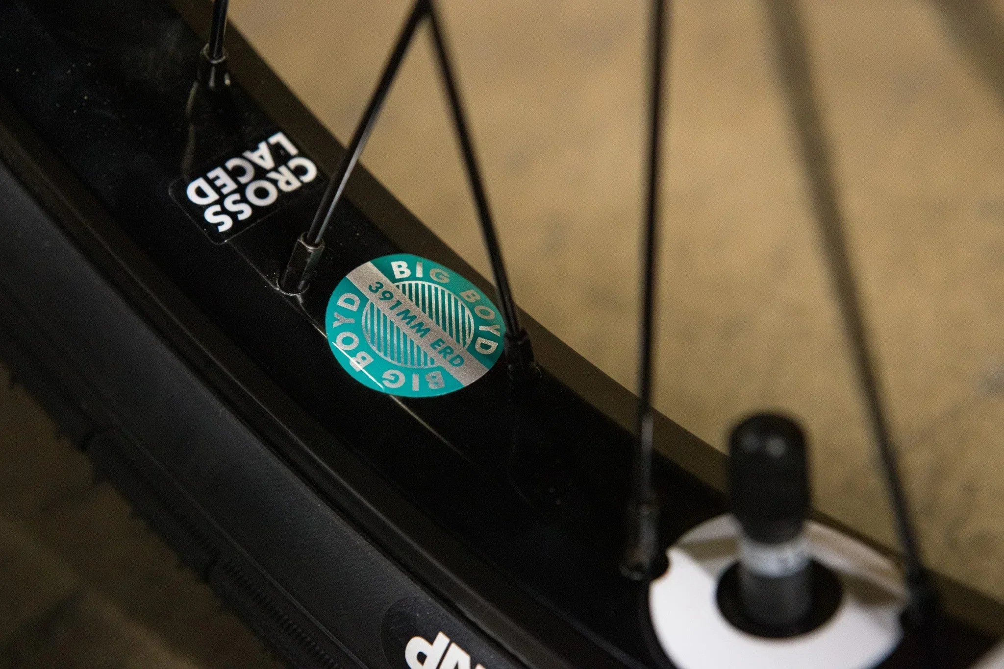 Détail d'une jante de vélo noire avec autocollant technique de diamètre ERD 391mm.