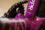 Gros plan d'un cadre de vélo BMX violet avec chaîne et plateau