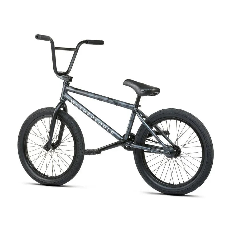 Vélo BMX noir avec cadre texturé et inscription 'WE THE PEOPLE', idéal pour tricks et freestyle.
