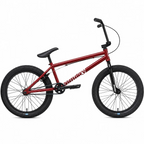 Vélo BMX Sunday rouge avec cadre métallique, pneus noirs et guidon relevé sur fond blanc.