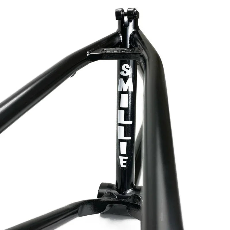 Black BMX frame close-up with 'SMILLIE' in white letters on the seat tube.