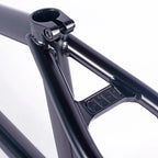 Close-up of black BMX bike frame seat clamp and gusset with 'CULT' engraving