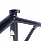 Close-up of black BMX bike frame seat tube with integrated clamp and bold lettering