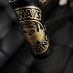 Close-up of matte black BMX bike frame with detailed gold skull graphic and bold lettering.