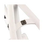 Matte white BMX frame close-up showing metal badge detail on rear triangle.