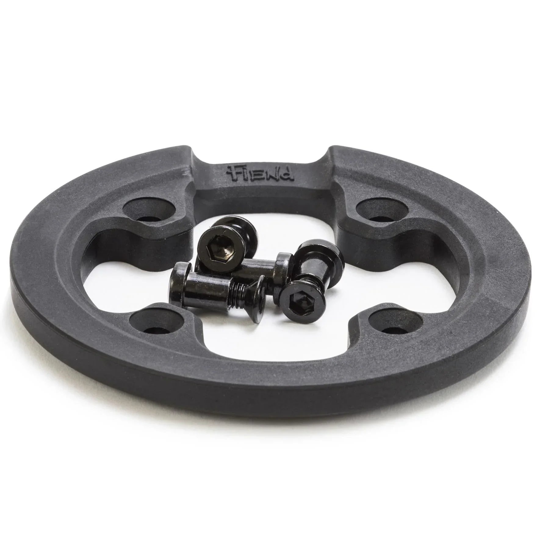 Black BMX sprocket guard with four mounting bolts on white background