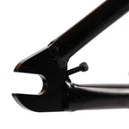 Close-up of black BMX frame dropout and chain tensioner bolt, showing welding detail