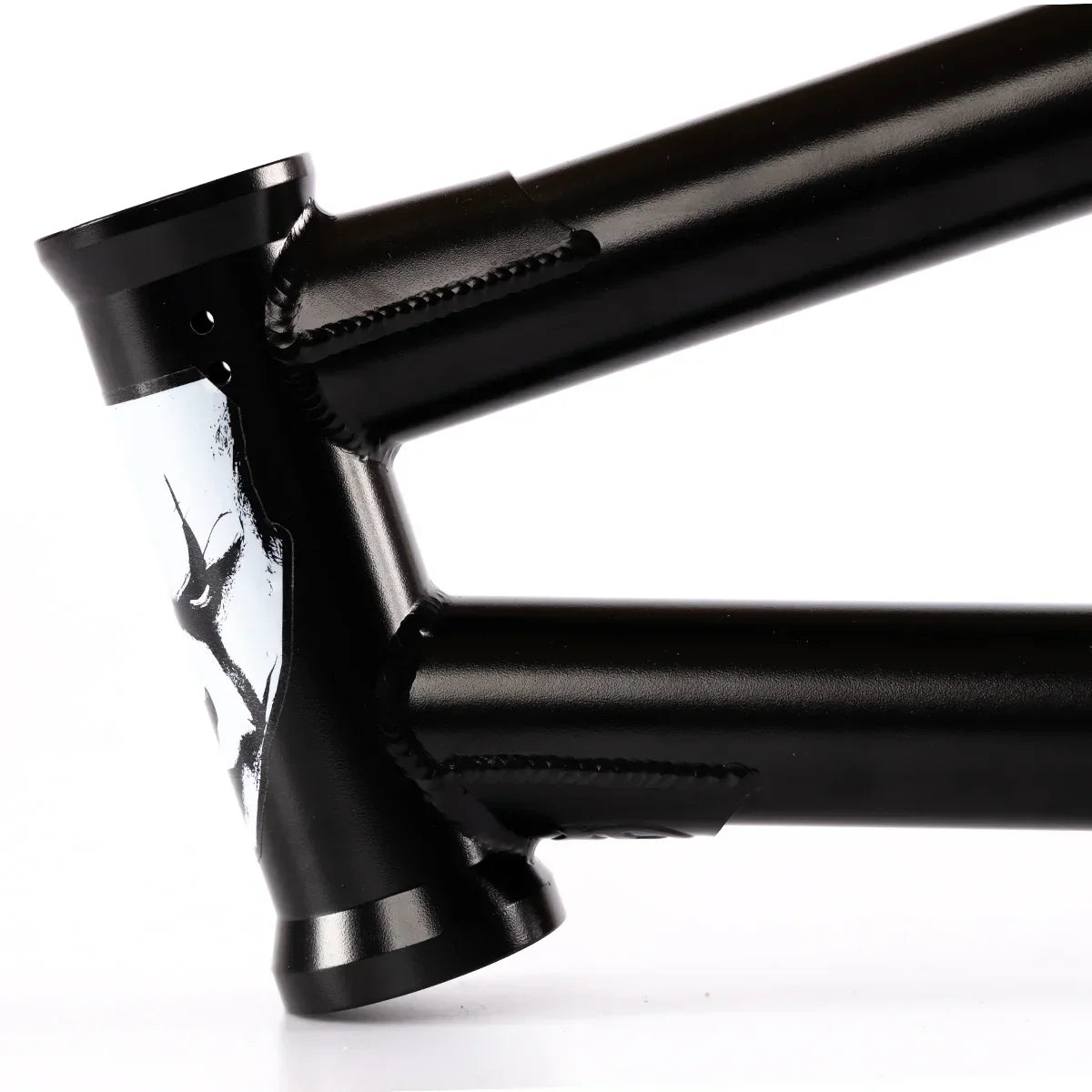 Black BMX bike frame closeup with detailed welds and distinctive head tube graphic