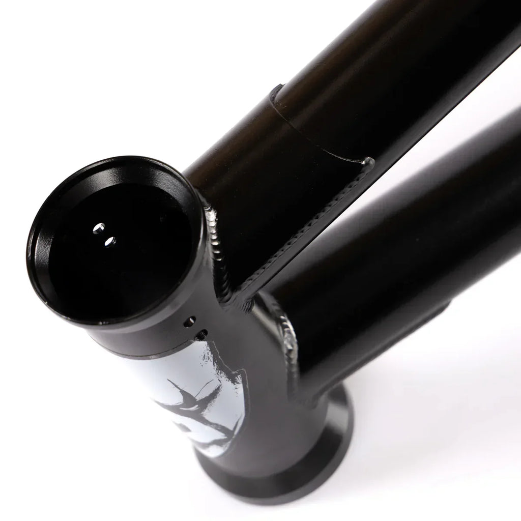 Close-up of a black BMX bike frame head tube with white graphic and visible welding details