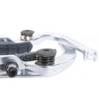 Close-up of a silver BMX bike brake arm with tension spring and visible hardware