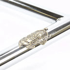 Chrome BMX handlebar detail with engraved metal badge and polished finish