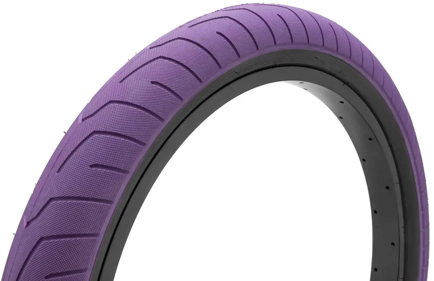 Purple BMX bike tire with textured tread pattern, close-up on white background