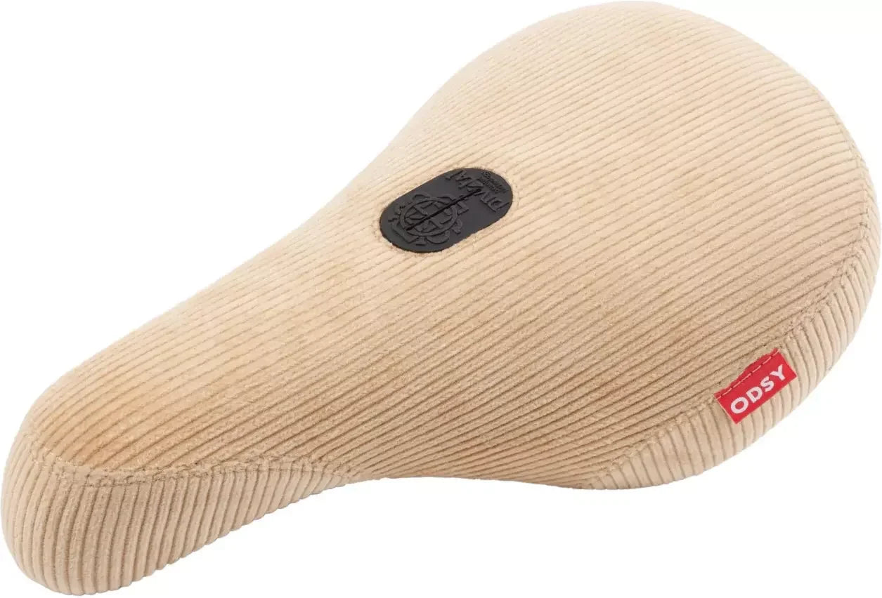 Selle BMX en velours côtelé beige avec logo ODSY, confortable et stylée pour vélo freestyle