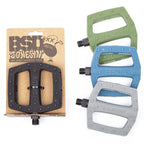 Pedales BMX Jonesin' en noir, vert, bleu et gris, avec emballage signature Sam Jones