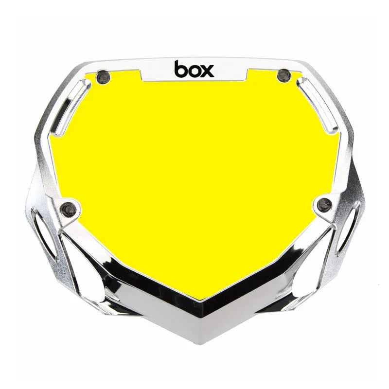 plaque guidon BMX jaune vif avec cadre chromé et logo 'box', accessoire de vélo de freestyle