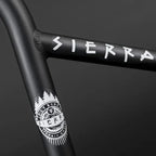 Close-up of black BMX handlebars with white Sierra graphics and logo detailing