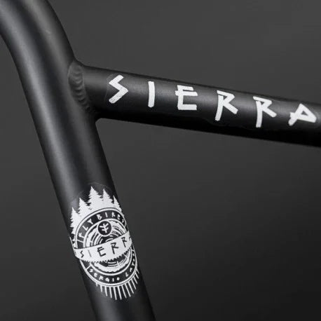 Close-up of black BMX handlebars with white Sierra graphics and logo detailing