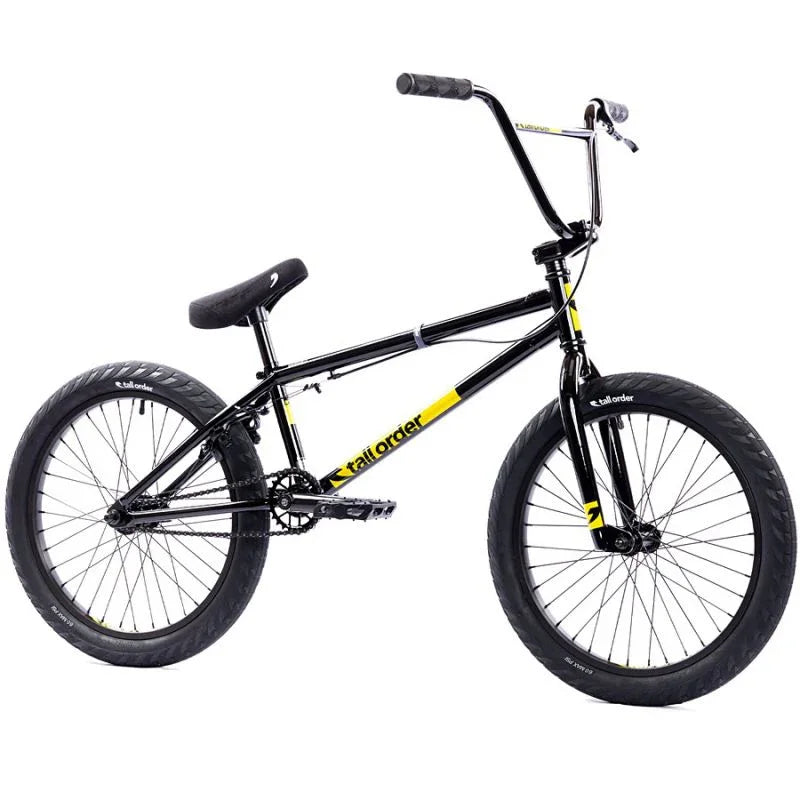 Vélo BMX noir et jaune avec cadre robuste, pneus larges et guidon haut pour tricks et freestyle
