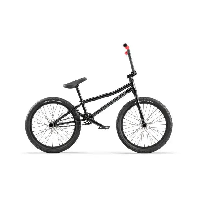 Vélo BMX noir avec guidon rouge, pneus larges et cadre robuste pour tricks et freestyle