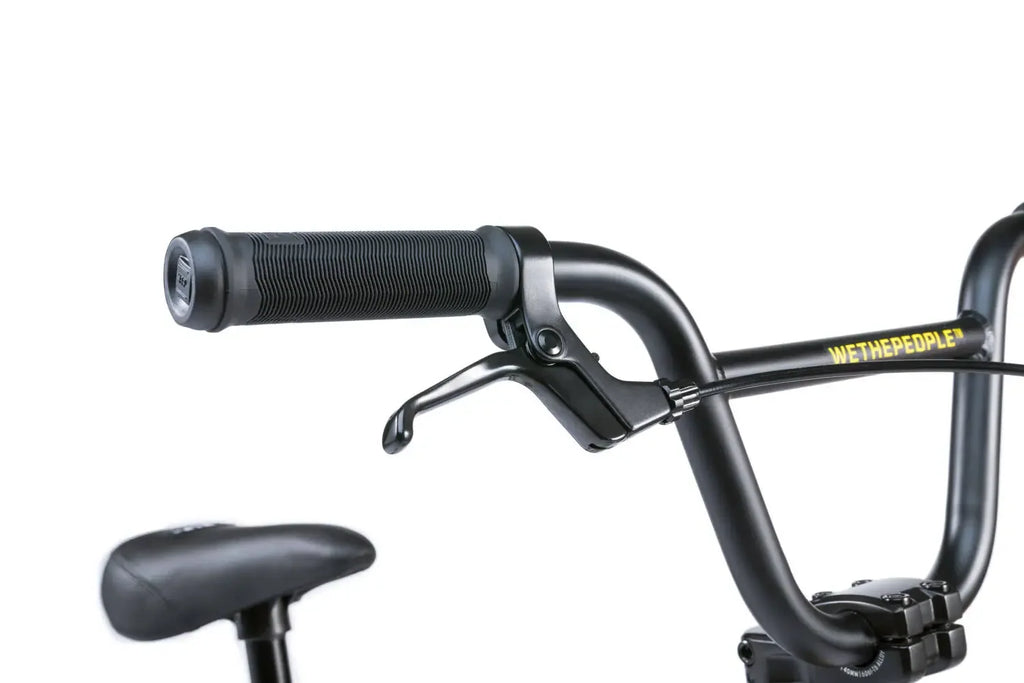 Guidon BMX noir avec poignées texturées et levier de frein, cadre avec inscription jaune