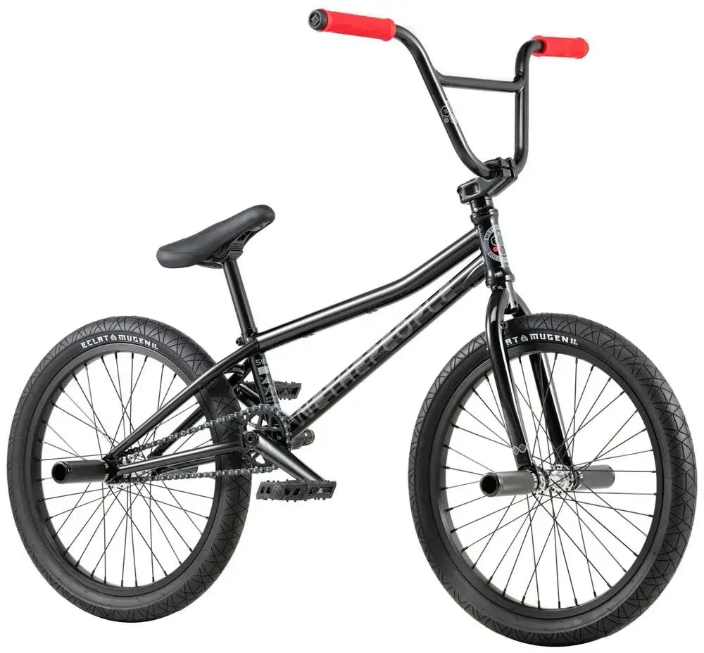 Vélo BMX noir avec poignées rouges et pneus robustes pour tricks et freestyle