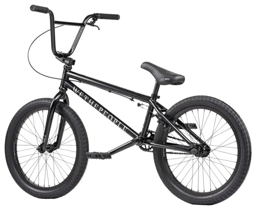Vélo BMX noir complet avec cadre WE THE PEOPLE, idéal pour tricks et freestyle