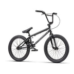Vélo BMX noir complet avec cadre et roues noires, idéal pour tricks et freestyle